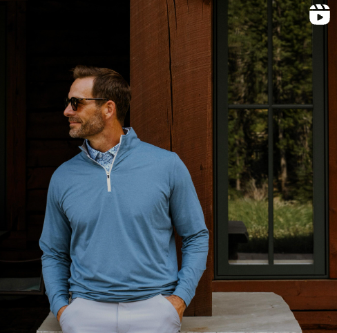 Man leaning against a post wearing the GenTeal Oceanic Heathered Venture Performance Quarter-Zip 